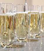 Image of champagne glasses on a table at a funeral reception